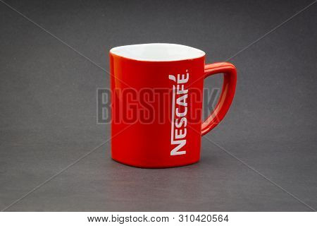 Kuala Lumpur, Malaysia - July 03, 2019; Promotional Red Nescafe Mug On Dark Background. Selective Fo