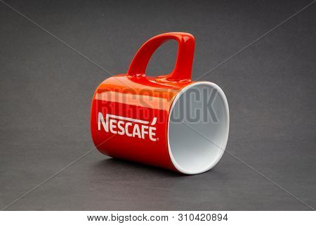 Kuala Lumpur, Malaysia - July 03, 2019; Promotional Red Nescafe Mug On Dark Background. Selective Fo