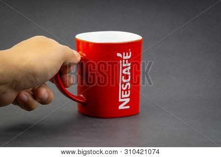 Kuala Lumpur, Malaysia - July 03, 2019; Promotional Red Nescafe Mug On Dark Background. Selective Fo
