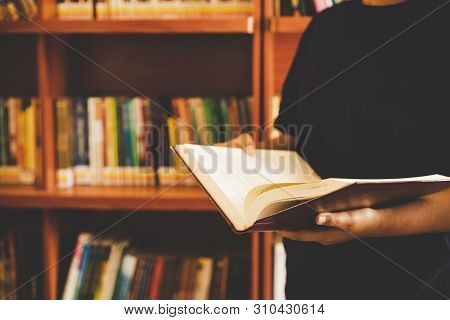 In The Library - Young Girl Student With Books Working In A High School Library.