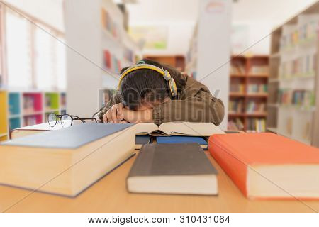 Portrait Of Beautiful Tired Brunette Student Girl Sitting Among The Books