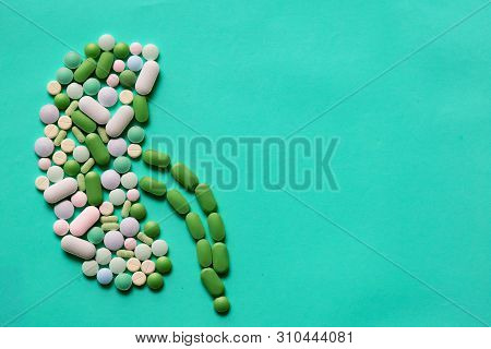 Medicine Pills Tablets Capsules In Shape Of Human Kidney In Blue Background With Space For Text
