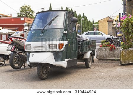 Certaldo, Italy - September 17, 2018: This Is An Italian Commercial Cargo Scooter Piaggio Ape 50 Cat