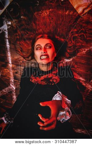 A portrait of a scary witch indoor. Magic, dark force, spell. Exorcism.