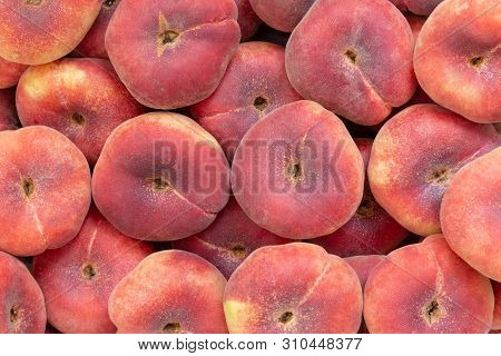 Fresh Saturn Peaches Or Donut Peaches Piled Up