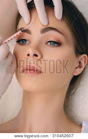 Woman Gets An Injection Blocking Mimic Wrinkles On The Forehead Area