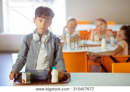 Dark-haired Boy Feeling Like Outcast While Eating Alone In Canteen