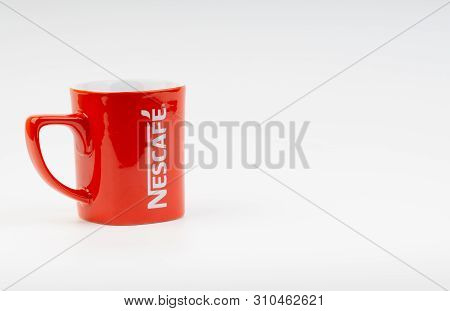 Kuala Lumpur, Malaysia - July 03, 2019:  Promotional Red Nescafe Mug On White Background. Selective 