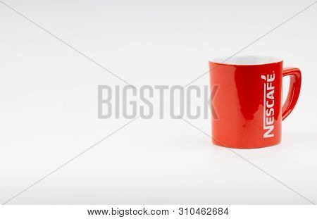 Kuala Lumpur, Malaysia - July 03, 2019:  Promotional Red Nescafe Mug On White Background. Selective 
