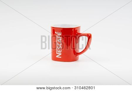Kuala Lumpur, Malaysia - July 03, 2019:  Promotional Red Nescafe Mug On White Background. Selective 