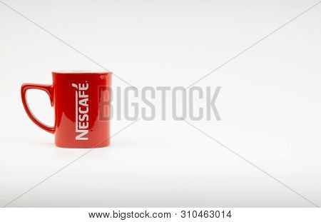 Kuala Lumpur, Malaysia - July 03, 2019:  Promotional Red Nescafe Mug On White Background. Selective 