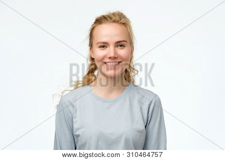 Headshot Portrait Of Happy Blonde Girl In Blue Pulover Smiling