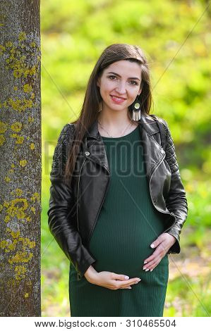 Portrait Of A Beautiful Pregnant Brunette. Young Beautiful Pregnant Woman With Long Dark Hair.