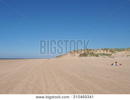 Formby, Merseyside, United Kingdom - 28 June 2019: A View Of The Long Sandy Beach In Formby Merseysi