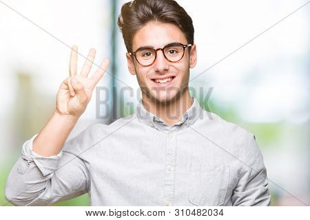 Young handsome man wearing glasses over isolated background showing and pointing up with fingers number three while smiling confident and happy.