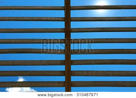 View Of The Sky Through The Wooden Lattice On A Sunny Day.