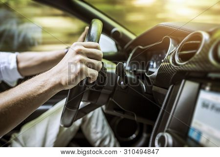 Modern Car Driving Concept. Caucasian Driver Inside Sporty Vehicle. Automotive Theme