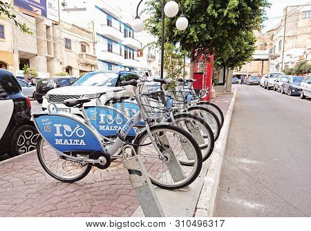 Naxxar, Malta - September 29, 2018: Maltas Public Bicycle Sharing Dock Station In Naxxar. Bicycle Sh