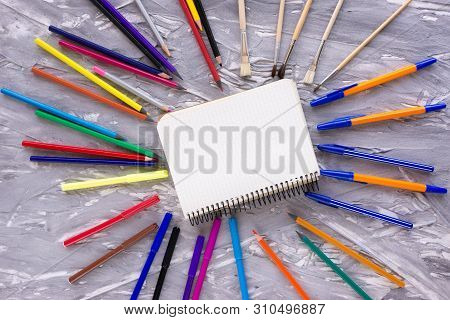 Photo Above On A Gray Background Is For Writing And Notebook. Charges Child In School.