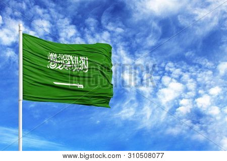 National Flag Of Saudi Arabia On A Flagpole In Front Of Blue Sky