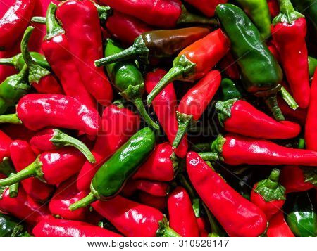 Red And Green Chilli Peppers. Close Up Over Head View Of The Freshly Picked Fruits.