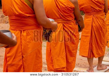 There Was A Merit Making In The Morning. People Would Scoop Food Into The Alms Of Many Monks.