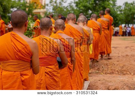 There Was A Merit Making In The Morning. People Would Scoop Food Into The Alms Of Many Monks.