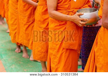 There Was A Merit Making In The Morning. People Would Scoop Food Into The Alms Of Many Monks.