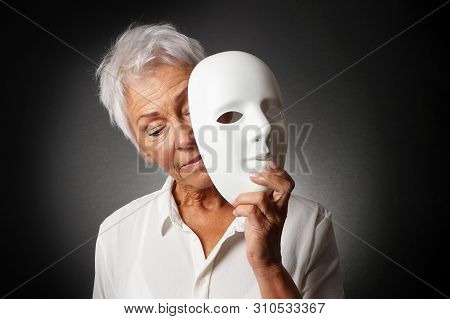 Older Woman With White Hair Hiding Sad Face Behind Mask - Depression Or Personality Concept