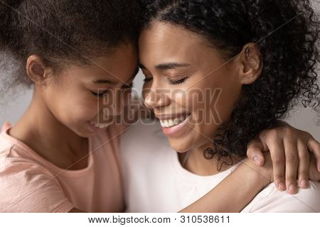 Loving Affectionate African Mother Embrace Cute Little Kid Daughter