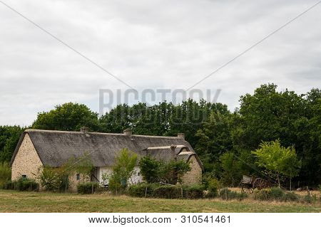 Old House In Saint Lyphard (france) With A Thatched Roof
