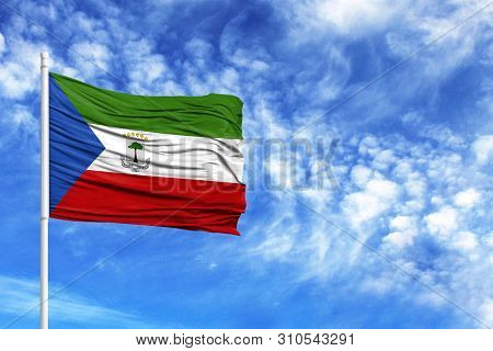 National Flag Of Equatorial Guinea On A Flagpole In Front Of Blue Sky
