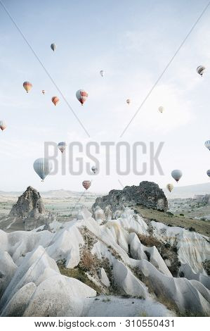 Hot Air Balloons Landing In A Mountain Cappadocia Goreme National Park Turkey.