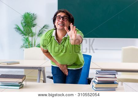 Male student suffering from urge in the classroom  