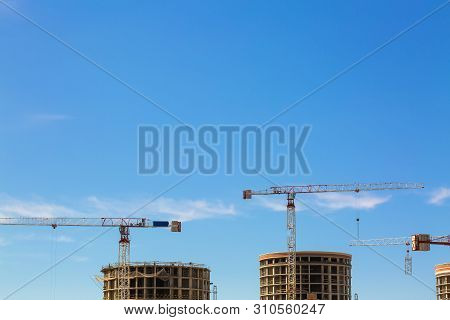 Industrial Construction Crane Or Column-jib Crane With Cabin Works  On The Construction Site And Vio