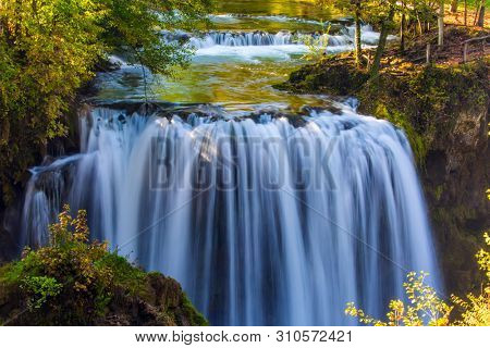 The small Croatian town. Numerous picturesque waterfalls of the Sluncica River flowing through the city. Magnificent dense forests surround and the river. The concept of ecological,  photo tourism