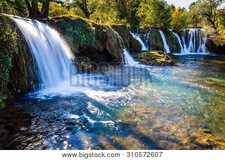 Magnificent cascade of waterfalls on the river Sluncica. The small Croatian town of Slunj. Beautiful sunny day. The concept of ecological, active and photo tourism