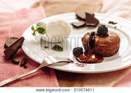 Chocolate Fondan With Syrup And Ice-cream On A Plate Decorated With Mint Leaves.