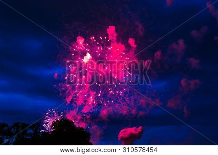 Inexpensive Fireworks Over The City Red, Pink And White. Bright And Shiny.  For Any Purpose. Celebra