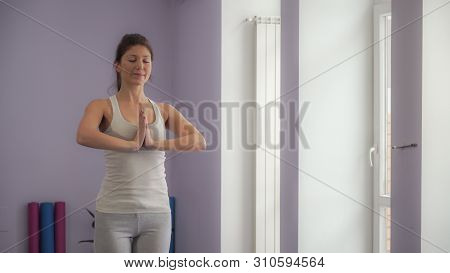 Attractive Woman Pelaxing After Yoga Exercises And Smiling