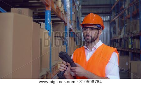 Manager Using Wireless Barcode Scanner Scanning Labels On Boxes Before Delivery In Logistic Center. 