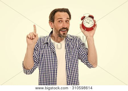 Keeping Track Of Time. Mature Timekeeper With Analog Clock Pointing Finger Up. Mature Man Holding Al