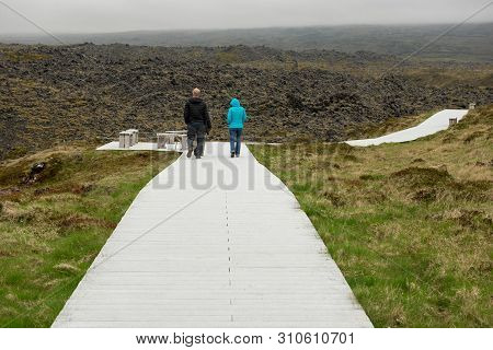 Tourists Trekking In Dritvik, Iceland