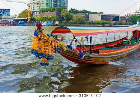 Bangkok, Thailand - January 03, 2016: Thai Narrow Wooden Boat Decorated With Flower Garland. Tourist