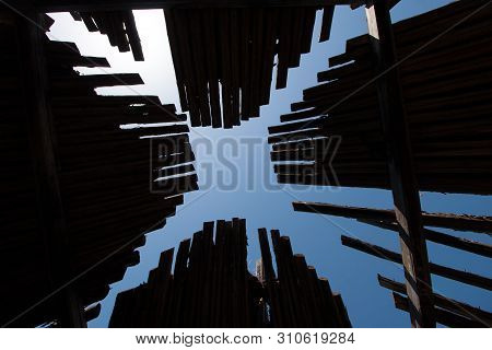 Wooden Roof Dark Old Yurt With Sky. Bottom Up Through The Roof To The Sky. The Roof Of The Wooden Tr