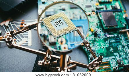 Disassembled Computer Components. Cpu Processor Analysis Through Magnifying Glass. Pc Electronic Par