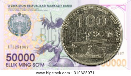 100 Uzbek Som Coin Against 50000 Uzbek Som Banknote