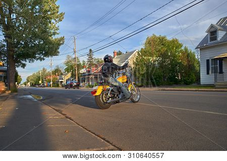 Montreal, Quebec, Canada, September 1, 2018. Woman On A Yellow Harley Davidson Motorcycle. Moves Alo