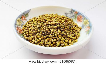 Coriander Seeds In Bowl Isolated On White Background