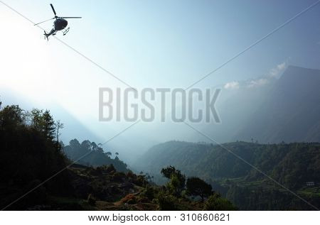 Helicopter flying over green Himalaya mountains from TenzingâHillary Airport in Lukla, Nepal